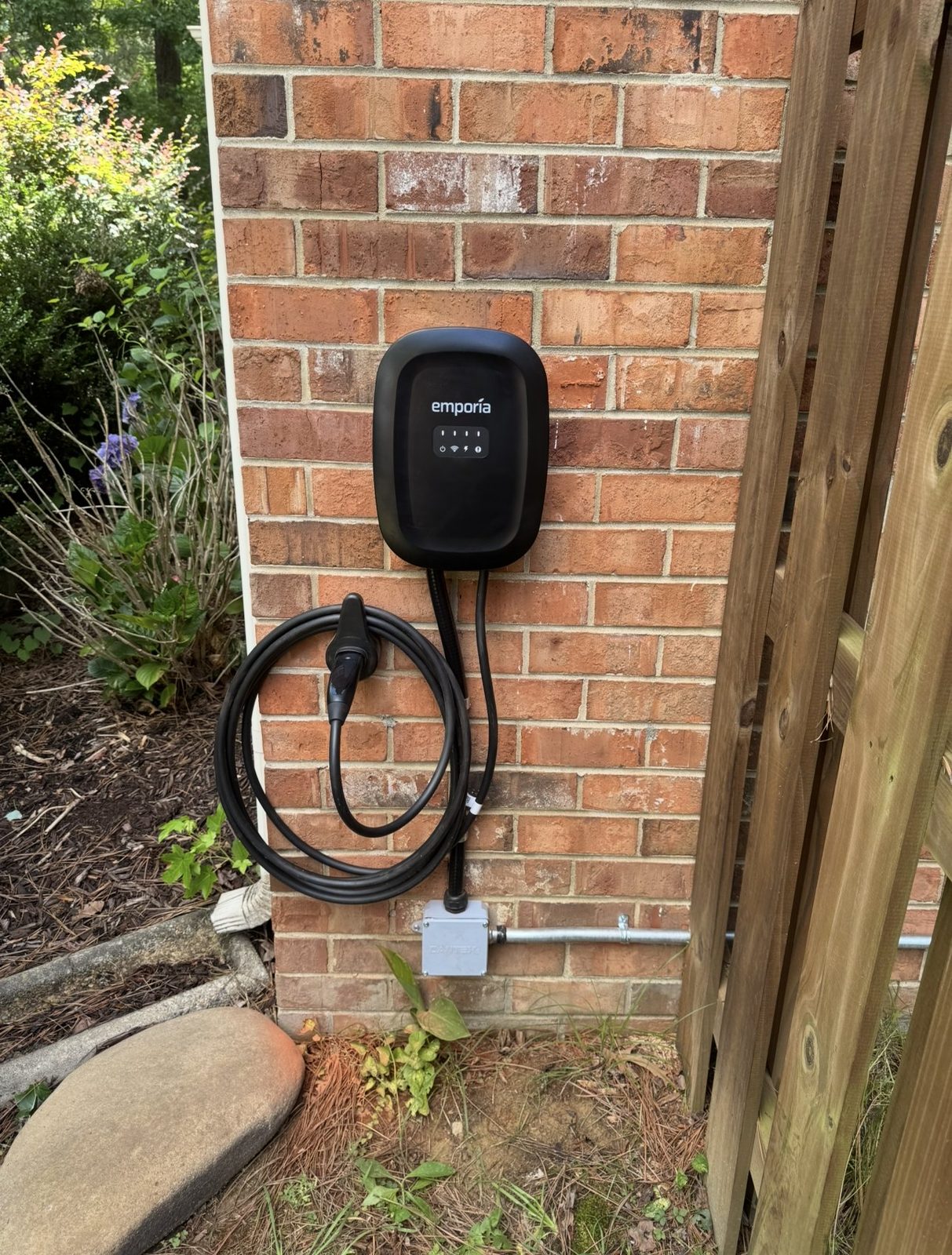 Emporia Level 2 EV charger installed by GreenKey on a brick Central Virginia home